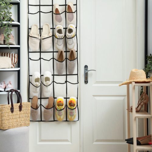 A white double door features hanging shoe storage, tall white shelves on one side, and a smaller shelf on the other.